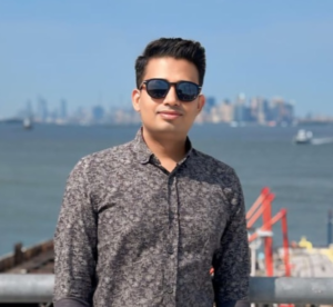 United Vision Turkiye's President Mr. Kavi Kaplan standing wearing glasses at the shipyard