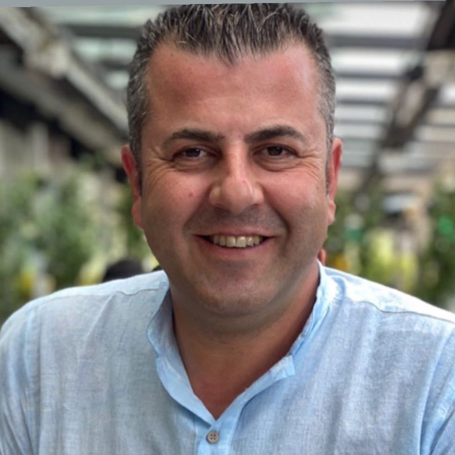 United Vision Türkiye's Vice President Dursun Teper sitting with a smiling face in a light blue shirt